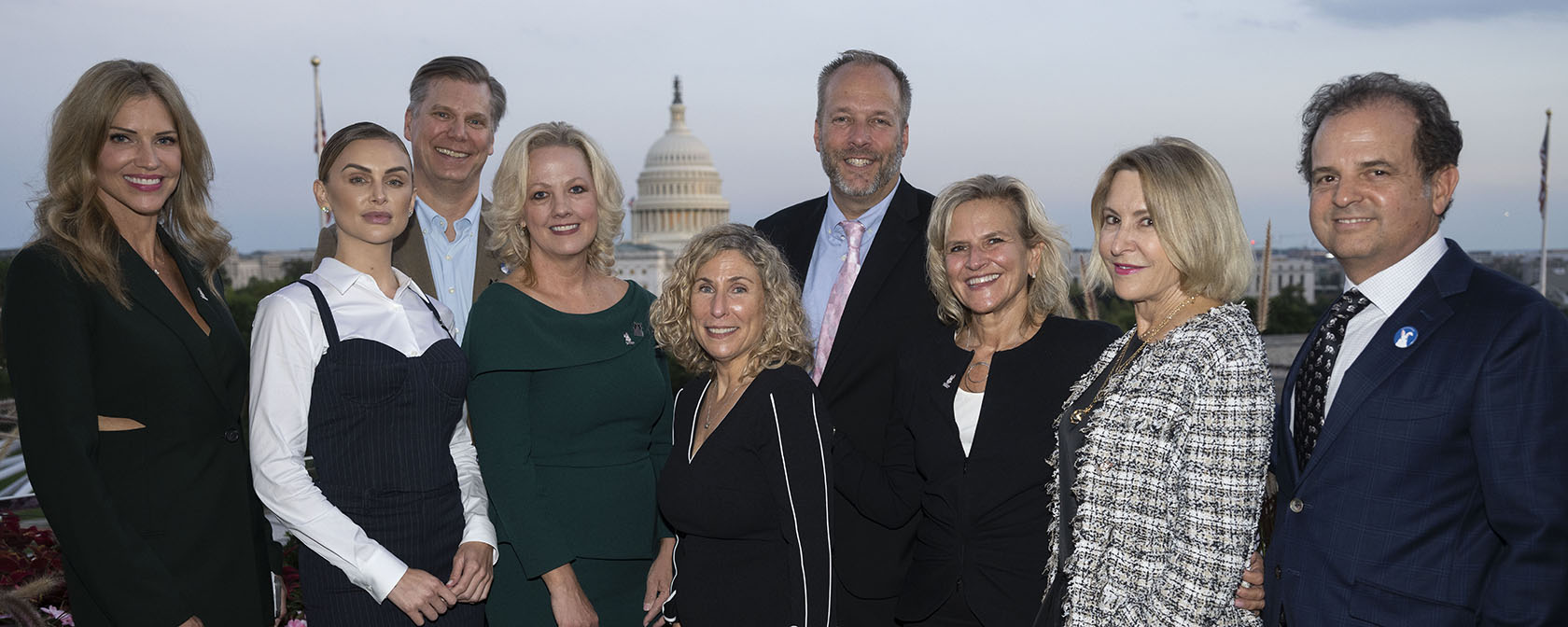 a group of people in front of the Capitol dome