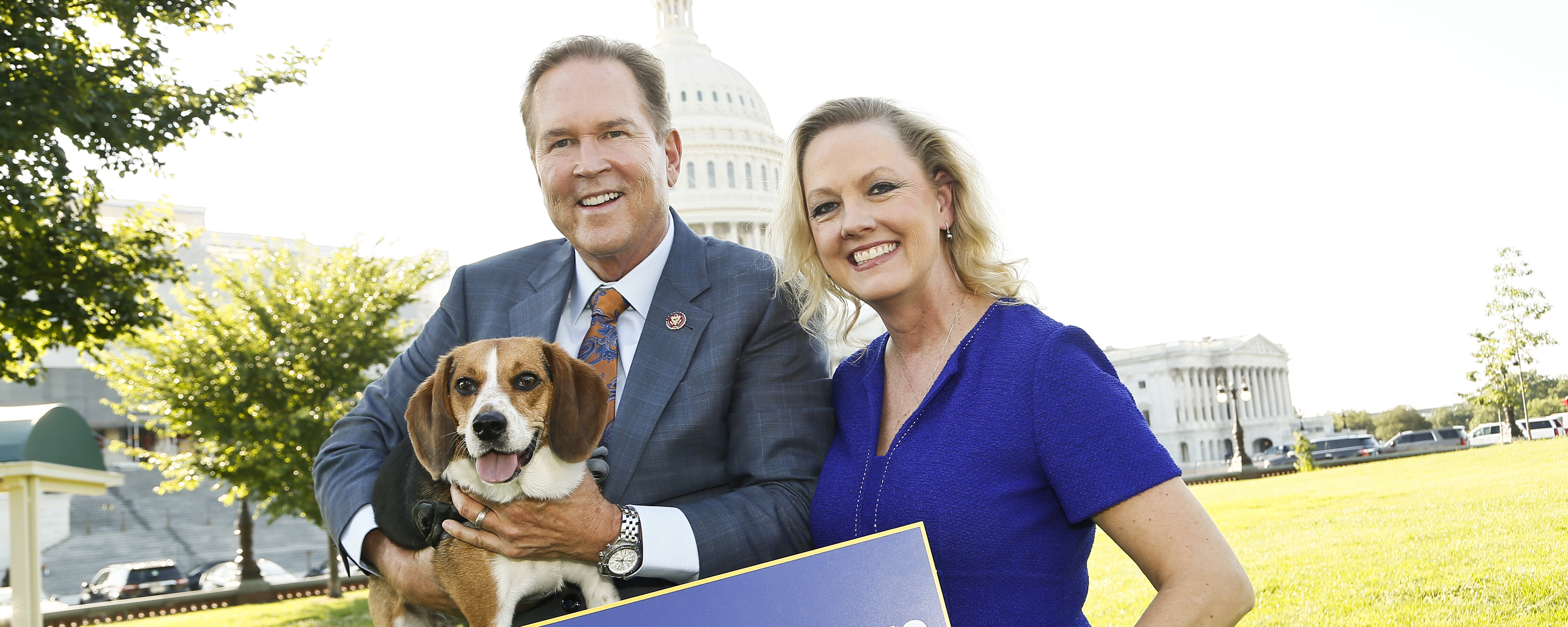 woman and a man holding a beagle