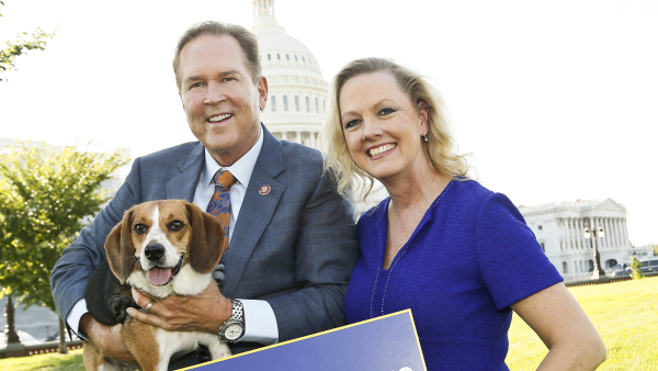 woman and a man holding a beagle