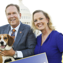 woman and a man holding a beagle